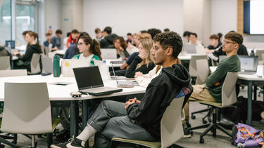 Group of students sat listening in a teaching session 