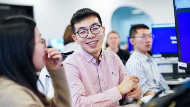 Two Information School students laughing.